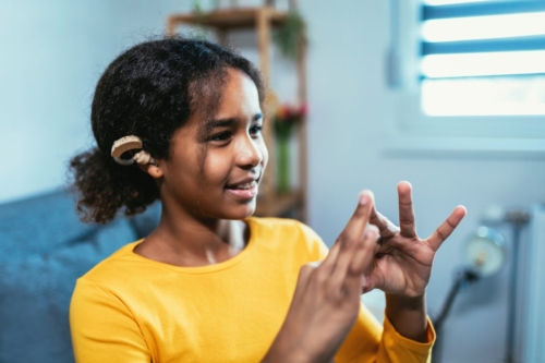 Young girl making hand signs