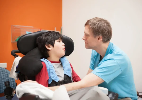 Boy with IDD With Doctor in the Clinic