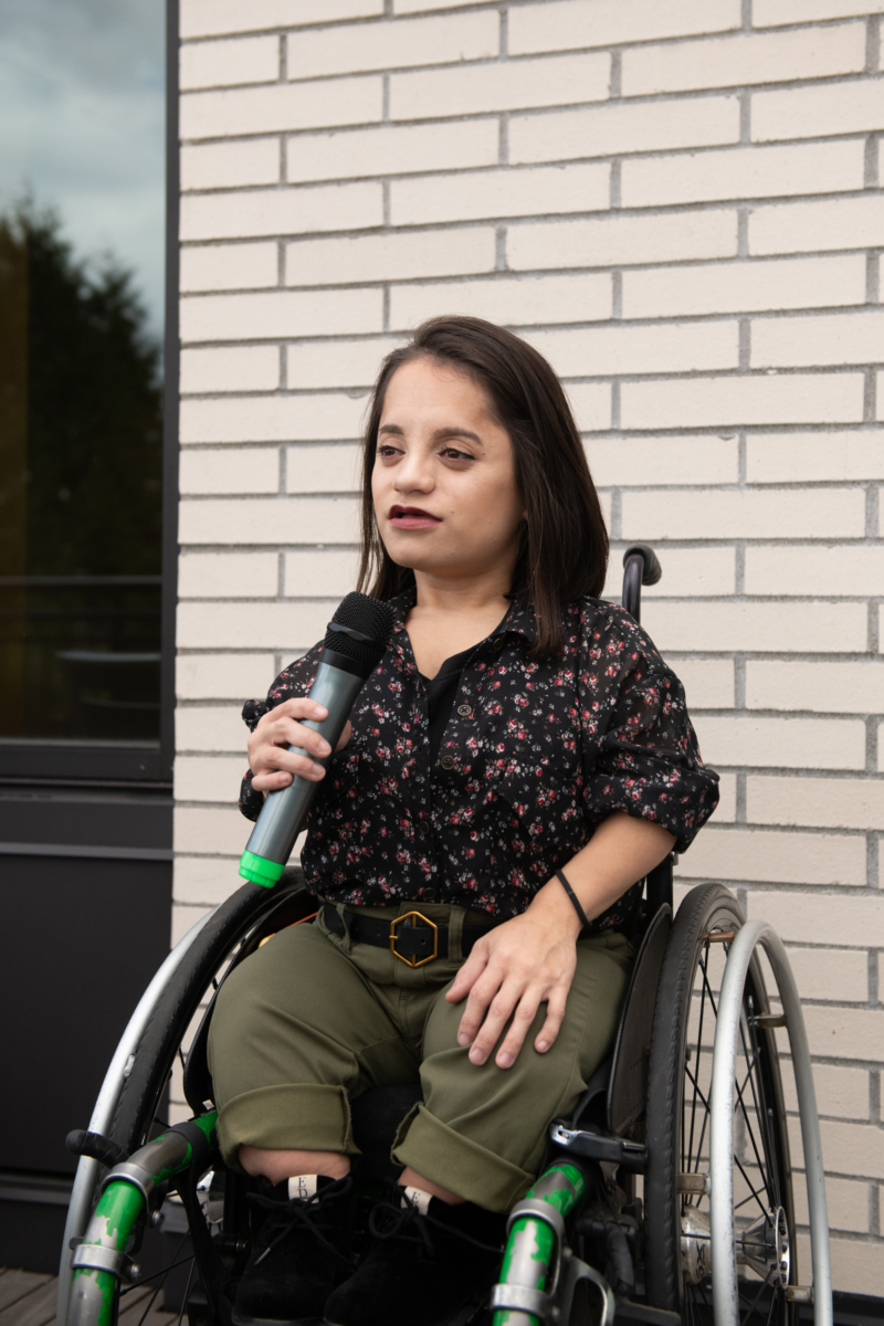 Woman in Wheelchair Speaking on Microphone